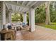 Covered outdoor seating area with comfortable furniture and a view of the lush backyard at 732 Gate Post Dr, Mount Pleasant, SC 29464