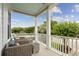 Inviting covered porch with comfortable seating and a view of the beautifully landscaped neighborhood at 732 Gate Post Dr, Mount Pleasant, SC 29464