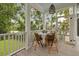 Charming screened porch with dining table and scenic outdoor views surrounded by lush greenery at 732 Gate Post Dr, Mount Pleasant, SC 29464