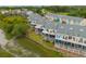 Aerial view of townhomes featuring balconies, backyard lawn space, and vibrant color schemes at 81 Sandbar Ln # 23, Folly Beach, SC 29439