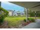 Lush backyard showing a water view, green grass, healthy foliage, and exterior architecture at 81 Sandbar Ln # 23, Folly Beach, SC 29439