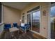 Cozy balcony with comfortable blue seating, a welcome mat, and views of the neighborhood at 81 Sandbar Ln # 23, Folly Beach, SC 29439