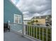 Balcony overlooking marsh with blue siding and white railings at 81 Sandbar Ln # 23, Folly Beach, SC 29439
