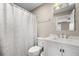 Well-lit bathroom featuring a white vanity with modern fixtures and a shower with a white curtain at 81 Sandbar Ln # 23, Folly Beach, SC 29439