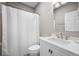Bright bathroom featuring a shower with white shower curtain, white cabinets and vanity and a modern faucet at 81 Sandbar Ln # 23, Folly Beach, SC 29439