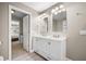 Bright bathroom featuring double sinks, modern lighting, and neutral walls at 81 Sandbar Ln # 23, Folly Beach, SC 29439