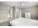 Bright bedroom featuring neutral walls, a ceiling fan, and views into an ensuite bathroom and closet at 81 Sandbar Ln # 23, Folly Beach, SC 29439