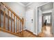 Inviting entryway showcasing hardwood floors, stairs with wood railing, and a convenient coat rack at 81 Sandbar Ln # 23, Folly Beach, SC 29439