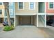 Carport-style garages underneath condo units, showing a gray car parked under unit 21 and a black car at unit 24 at 81 Sandbar Ln # 23, Folly Beach, SC 29439