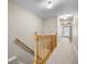 Spacious hallway with carpet flooring, wood banister, and neutral paint, leading to multiple rooms at 81 Sandbar Ln # 23, Folly Beach, SC 29439
