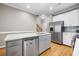 Modern kitchen with stainless steel appliances, white cabinets, and hardwood floors at 81 Sandbar Ln # 23, Folly Beach, SC 29439