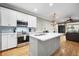 Modern kitchen featuring stainless steel appliances, a stylish island, and a gas range at 81 Sandbar Ln # 23, Folly Beach, SC 29439