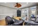 Spacious living room with hardwood floors, dark leather couches, and balcony access at 81 Sandbar Ln # 23, Folly Beach, SC 29439