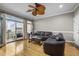 Comfortable living room with hardwood floors, ceiling fan, and sliding glass doors to the balcony at 81 Sandbar Ln # 23, Folly Beach, SC 29439