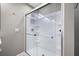Modern shower with glass enclosure, sleek fixtures, and convenient built-in shelving at 81 Sandbar Ln # 23, Folly Beach, SC 29439