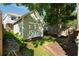 View of the backyard shed that sits adjacent to a quaint brick patio and lush green lawn at 815 Harbor Pl Dr, Charleston, SC 29412