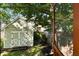 Backyard shed with double 'X' doors, surrounded by mature trees, offering extra storage and a peaceful outdoor space at 815 Harbor Pl Dr, Charleston, SC 29412