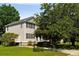Well-maintained two-story home featuring black shutters, lush greenery, and a spacious yard at 815 Harbor Pl Dr, Charleston, SC 29412