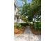 Landscaped front yard with walkway leading to a home entrance, surrounded by lush greenery at 815 Harbor Pl Dr, Charleston, SC 29412