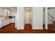 Hallway leading to bright kitchen with hardwood flooring throughout the home creating warmth and seamless transition at 815 Harbor Pl Dr, Charleston, SC 29412