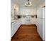 Bright, well-lit kitchen with white cabinets, hardwood floors, and stainless appliances offer a clean, modern feel at 815 Harbor Pl Dr, Charleston, SC 29412