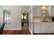 Kitchen with white cabinets and stainless-steel dishwasher leading to screened-in porch at 815 Harbor Pl Dr, Charleston, SC 29412