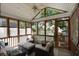 Enclosed porch featuring a ceiling fan, wicker furniture, and outdoor views at 815 Harbor Pl Dr, Charleston, SC 29412