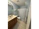 Well-lit bathroom showcasing a vanity with a wood finish, a commode, and a shower with a curtain at 9122 Maple Grove Dr, Summerville, SC 29485