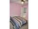 Cozy bedroom with pink walls, ceiling fan, and access to the hallway, perfect for a or guest room at 9122 Maple Grove Dr, Summerville, SC 29485