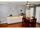 Eat-in dining area provides wood floors, a ceiling fan, storage cabinets with a serving counter and natural light at 9122 Maple Grove Dr, Summerville, SC 29485