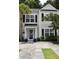 Charming townhome showcasing a well-manicured front yard, complemented by a quaint entrance adorned with a wreath at 9122 Maple Grove Dr, Summerville, SC 29485