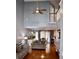 Spacious living room boasts soaring ceilings, hardwood floors, a ceiling fan and a view into the dining and kitchen area at 9122 Maple Grove Dr, Summerville, SC 29485