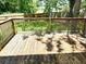A wooden back deck with a fenced in back yard and mature trees providing shade at 101 Limerick Cir, Summerville, SC 29483