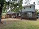 Back exterior with a brick facade, deck, and access to a spacious backyard, perfect for outdoor activities at 101 Limerick Cir, Summerville, SC 29483