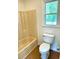 Bathroom featuring a tub shower, toilet, and window for natural light at 101 Limerick Cir, Summerville, SC 29483
