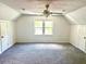 Large carpeted bedroom with ceiling fan, closet doors, and window views at 101 Limerick Cir, Summerville, SC 29483