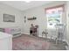 Bright Bedroom featuring a crib, rocking chair, and charming decor, perfect for a growing Gathering at 101 Patterson Ave, Goose Creek, SC 29445