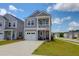 Charming two-story home with gray siding, a balcony, a well-manicured lawn, and a two car driveway at 101 Patterson Ave, Goose Creek, SC 29445