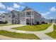 Two-story home with gray siding, well-manicured lawn, two car garage and other homes in the neighborhood at 101 Patterson Ave, Goose Creek, SC 29445