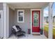 Inviting front porch with a red door, a wreath, outdoor seating, and flower pots, adding curb appeal at 101 Patterson Ave, Goose Creek, SC 29445