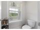 Cozy bathroom featuring a toilet, storage basket, and window letting in plenty of natural light at 1017 Saltwater Cir, Johns Island, SC 29455