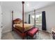Bedroom featuring unique red four-poster bed and bright window providing natural light and warmth at 1017 Saltwater Cir, Johns Island, SC 29455
