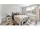 Sunlit bedroom with a comfortable bed, stylish side table, and large window with sheer curtains at 1017 Saltwater Cir, Johns Island, SC 29455