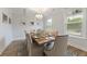 Cozy dining room with large windows and a decorative light fixture, ideal for Gathering gatherings at 1017 Saltwater Cir, Johns Island, SC 29455