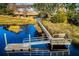 Aerial view of a community pier and dock on the waterfront with lush green surroundings at 1017 Saltwater Cir, Johns Island, SC 29455