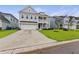 Inviting two-story home with a spacious driveway and lush green lawn at 1017 Saltwater Cir, Johns Island, SC 29455