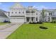 Charming two-story home with a well-manicured lawn and attached two-car garage at 1017 Saltwater Cir, Johns Island, SC 29455