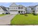 Stunning two-story home featuring a double garage, pristine lawn and attractive landscaping at 1017 Saltwater Cir, Johns Island, SC 29455