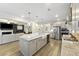Open-concept kitchen with stainless appliances, granite counters, and a view into the cozy living room at 1017 Saltwater Cir, Johns Island, SC 29455