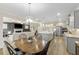 Spacious kitchen features stainless appliances, granite counters, and transitions to an open dining and living area at 1017 Saltwater Cir, Johns Island, SC 29455